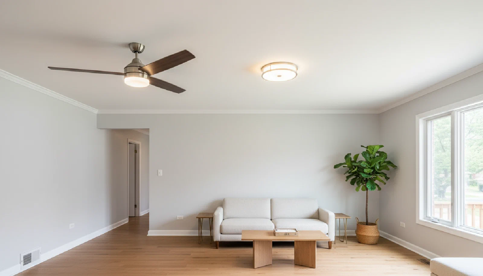 Bright interior with a newly installed ceiling fan and updated light fixture